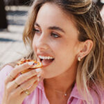 Pretty girl eating a pastel de nata Nata Pura